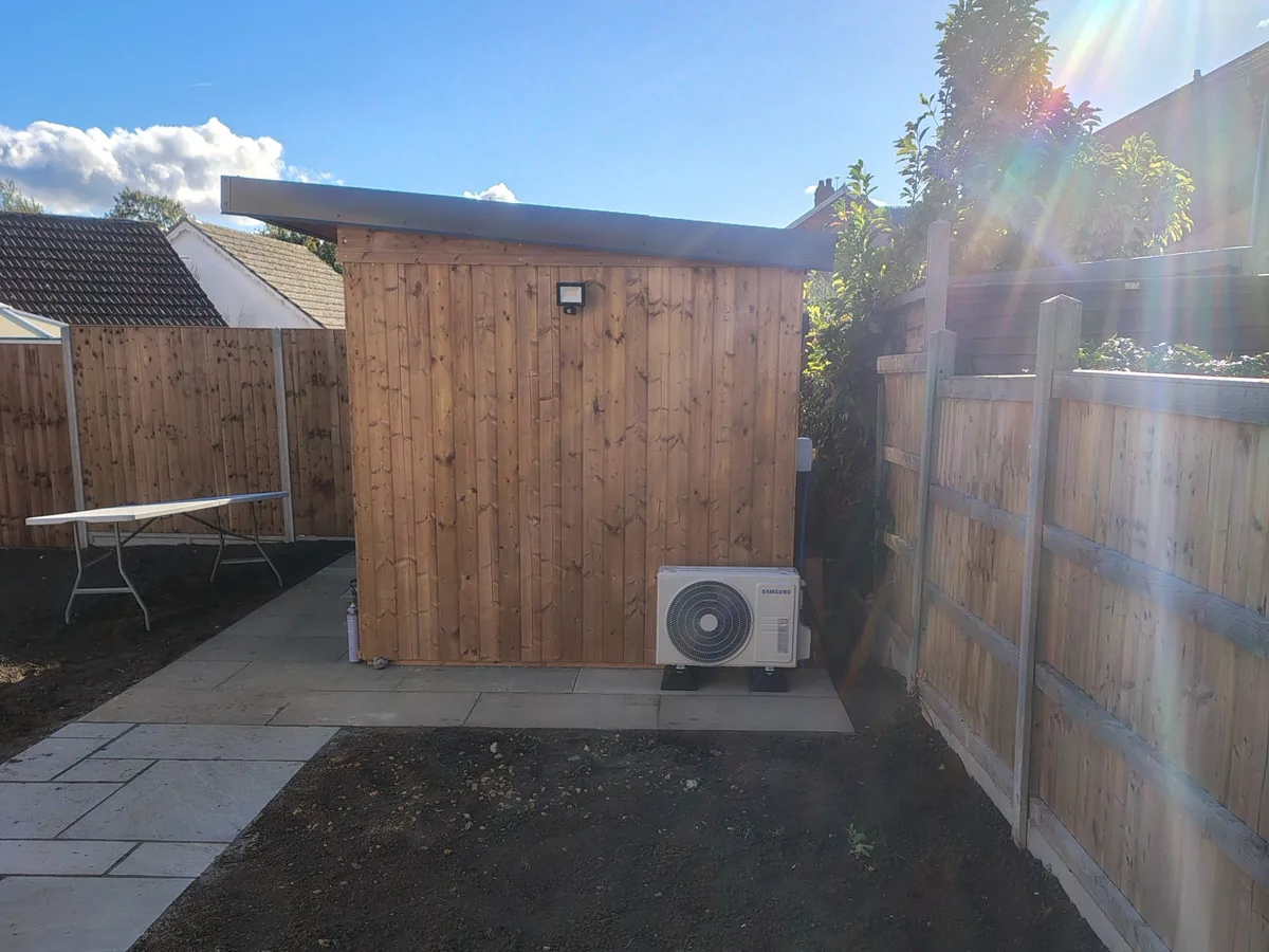 Exterior view of timber garden building with Samsung air conditioning condenser outside